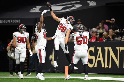 Tampa Bay Buccaneers linebacker Anthony Nelson (98) celebrates, including defensive tackle Vita Vea (50), defensive end Logan Hall (90) and defensive end Elijah Roberts (95) with teammates after returning an interception for a score during the first half of an NFL football game against the New Orleans Saints Sunday, Oct. 26, 2025, in New Orleans. (AP Photo/Ella Hall) Tampa Bay Buccaneers linebacker Anthony Nelson (98) celebrates, including defensive tackle Vita Vea (50), defensive end Logan Hall (90) and defensive end Elijah Roberts (95) with teammates after returning an interception for a score during the first half of an NFL football game against the New Orleans Saints Sunday, Oct. 26, 2025, in New Orleans. (AP Photo/Ella Hall)