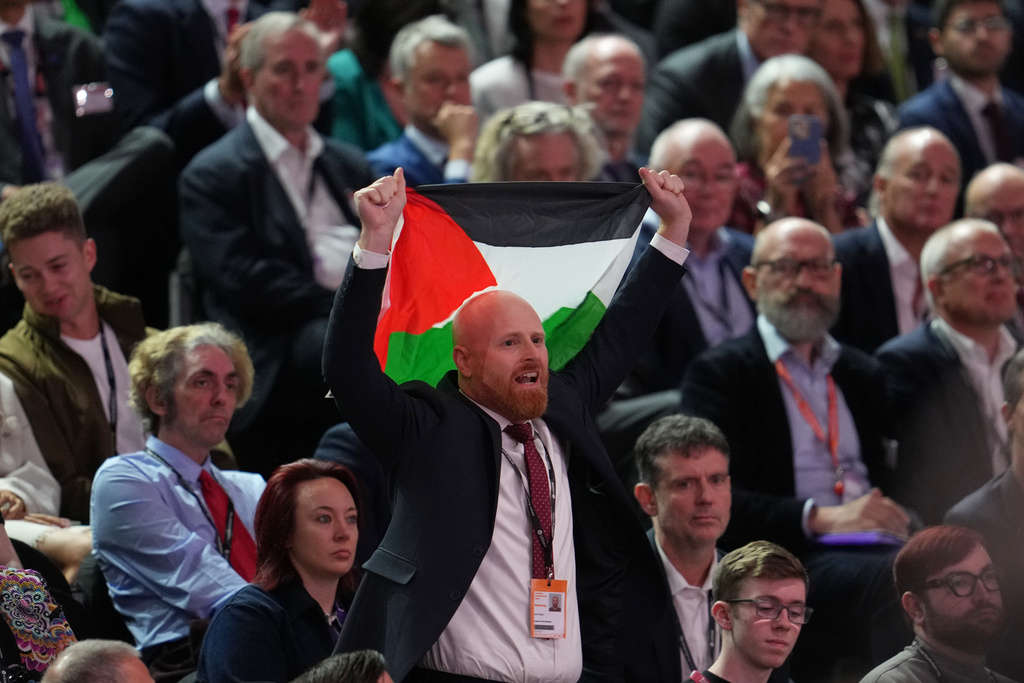 A protester holds up a Palestinian flag as he interrupts the keynote speech by Britain's Chancellor of the Exchequer Rachel Reeves during the annual Labour Party conference in Liverpool, England, Monday, Sept. 29, 2025. (AP Photo/Jon Super)
