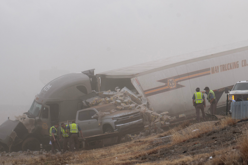 Emergency personnel work the scene of a crash involving 30-plus vehicles including six semi trucks on Interstate 25 south of Pueblo, Colo., on Tuesday, Feb. 17, 2026. (Christian Murdock/The Gazette via AP)