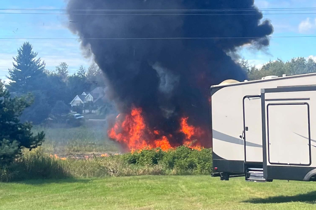 Smoke rises after an F-16 fighter jet crashed in a rural area near Traverse City, Mich., Thursday, Sept. 17, 2026. (Rebecca Lamberson via AP)
