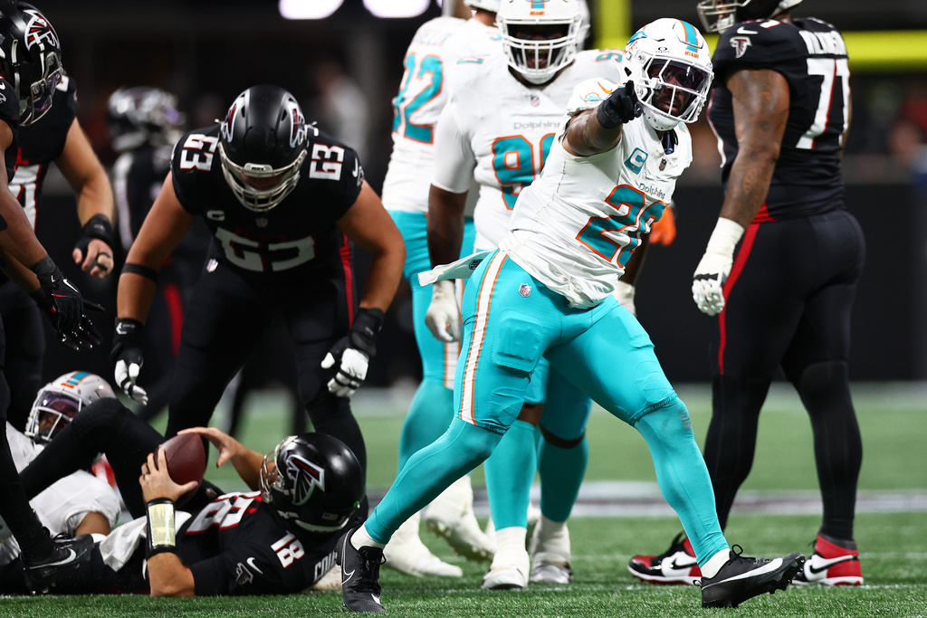 Miami Dolphins linebacker Jordyn Brooks (20) reacts after sacking Atlanta Falcons quarterback Kirk Cousins (18) during the first half of an NFL football game, Sunday, Oct. 26, 2025, in Atlanta. (AP Photo/Colin Hubbard)