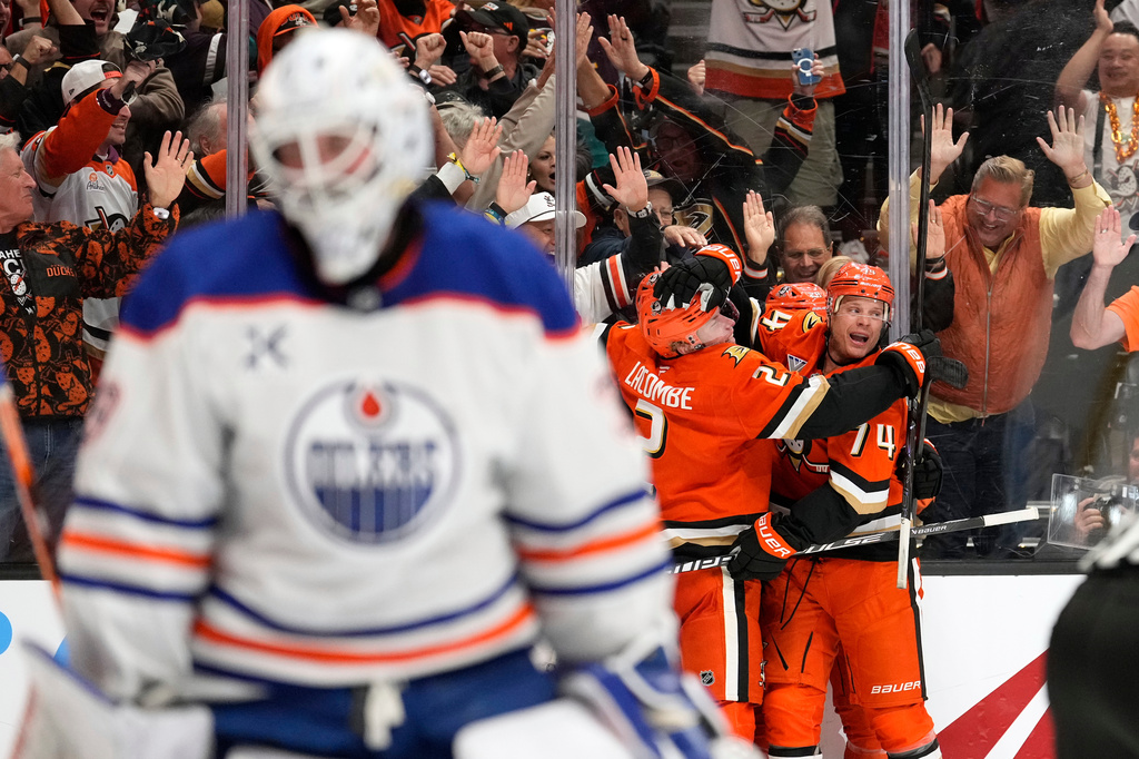 Anaheim Ducks left wing Jeffrey Viel, second from right, celebrates his goal with teammates as Edmonton Oilers goaltender Connor Ingram, left, stands in goal during the third period of Game 3 in the first round of the NHL hockey Stanley Cup playoffs series Friday, April 24, 2026, in Anaheim, Calif. (AP Photo/Mark J. Terrill)