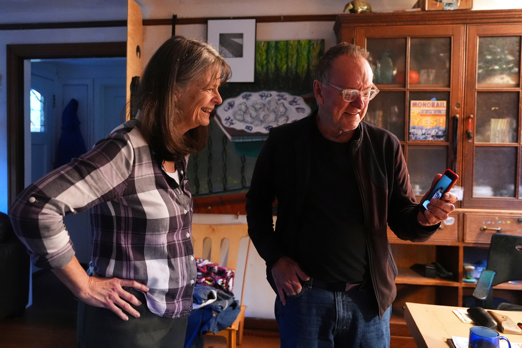 Mary E. Brunkow and her husband Ross Colquhoun talk with one of their daughters on the phone about her winning a Nobel Prize in medicine for part of her work on peripheral immune tolerance, in Seattle, Monday, Oct. 6, 2025. (AP Photo/Lindsey Wasson)