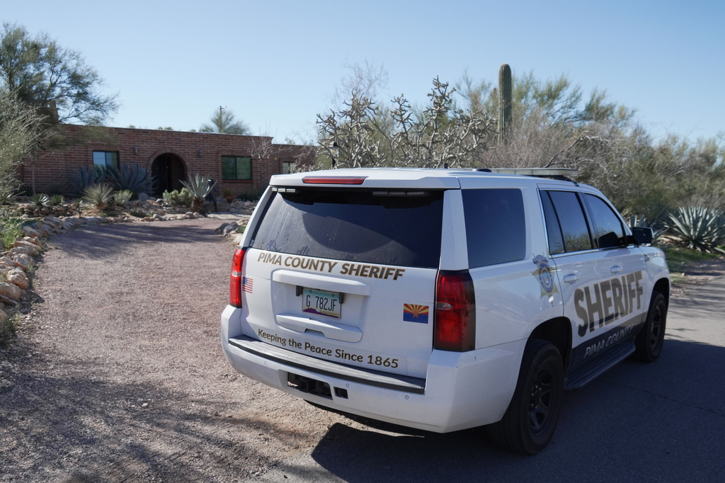 A Pima county sheriff's vehicle is parked out front of Nancy Guthrie’s home on Sunday, Feb. 8, 2026 in Tucson, Ariz. (AP Photo/Ty ONeil)