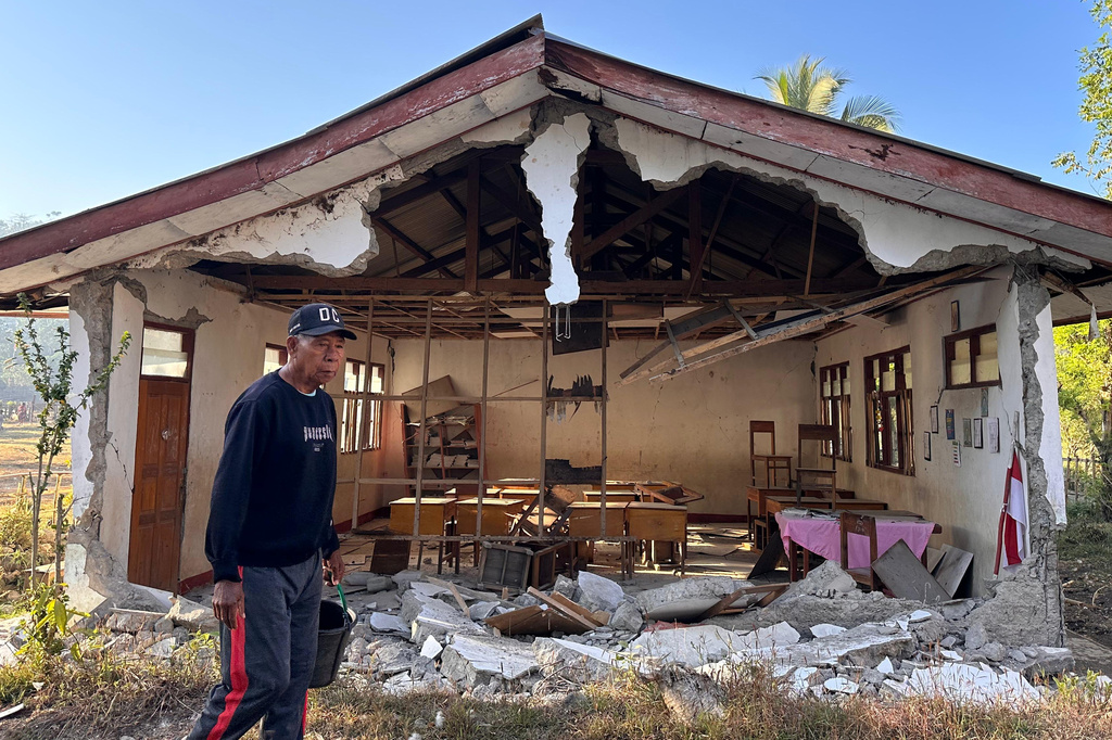 A man walks past an earthquake-damaged school in Satar Punda, East Nusa Tenggara province, Indonesia, Tuesday, Aug. 18, 2026. (AP Photo/Firdia Lisnawati)