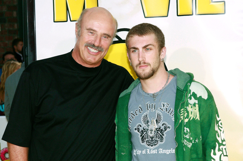 FILE - Dr. Phil McGraw, left, and his son, Jordan McGraw, arrive at the premiere of 'The Simpsons Movie' in Los Angeles, July 24, 2007. (AP Photo/Matt Sayles, File)