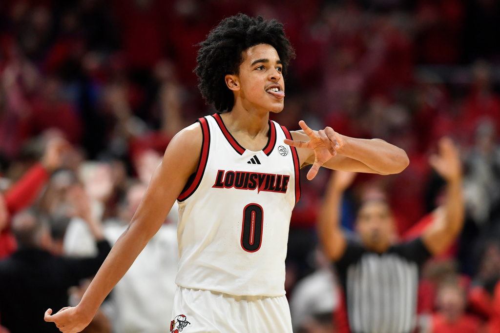 Louisville guard Mikel Brown Jr. (0) holds up three fingers after hitting a three point shot during the first half of an NCAA college basketball game against Kentucky in Louisville, Ky., Tuesday, Nov. 11, 2025. (AP Photo/Timothy D. Easley)