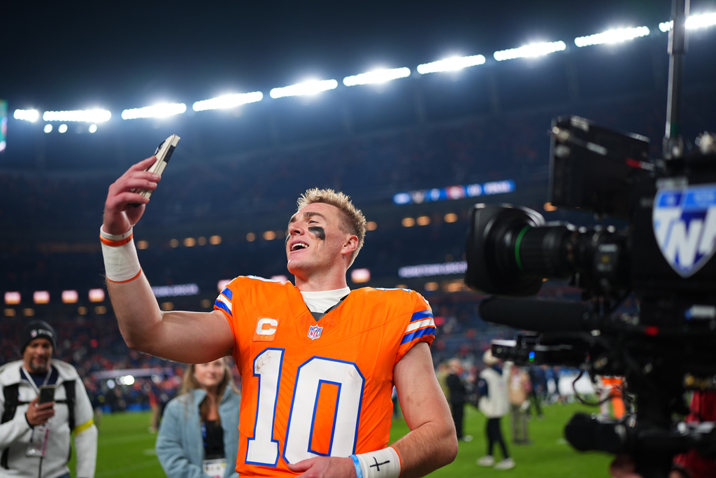 Denver Broncos quarterback Bo Nix (10) uses a phone following an NFL football game against the Las Vegas Raiders Thursday, Nov. 6, 2025, in Denver. (AP Photo/Jack Dempsey)