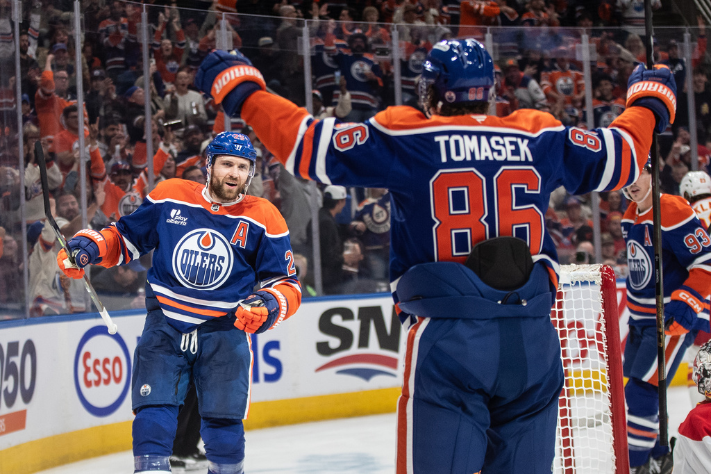 Edmonton Oilers' Leon Draisaitl (29) celebrates his 400th career goal with David Tomasek (86) against the Calgary Flames during second period NHL action, in Edmonton on Wednesday, Oct. 8, 2025. (Jason Franson/The Canadian Press via AP)