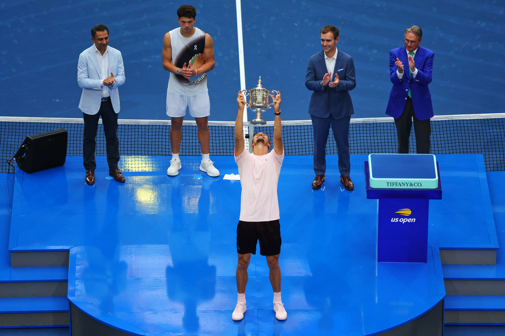 Alexander Zverev, of Germany, holds up his trophy after winning the men's singles final of the U.S. Open tennis championships against Ben Shelton, of the United States, Sunday, Sept. 13, 2026, in New York. (AP Photo/Andres Kudacki)