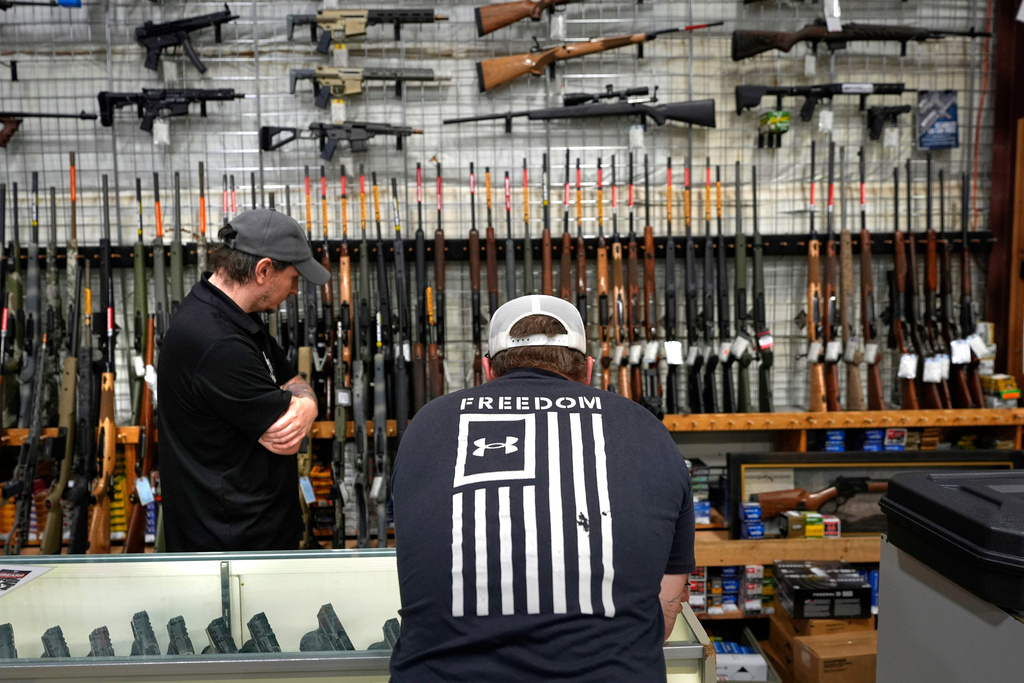 A customer shops at Maine Military Supply, Tuesday, Nov. 4, 2025, in Holden, Maine. (AP Photo/Robert F. Bukaty)