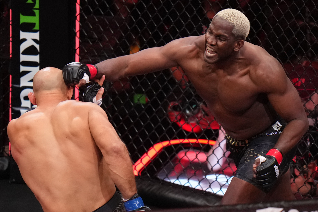 Robelis Despaigne, of Cuba, right, punches Junior dos Santos, of Brazil, during their heavyweight mixed martial arts fight Saturday, May 16, 2026, in Inglewood, Calif. (AP Photo/Jae C. Hong )