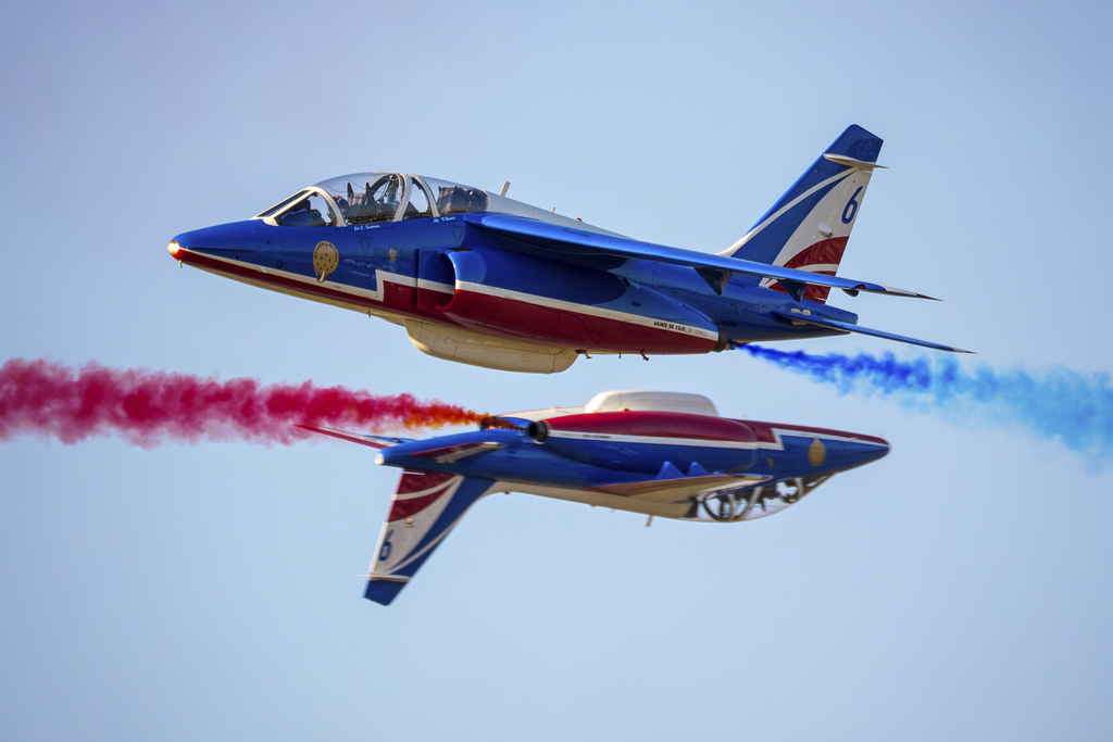 Pilots of the Patrouille de France (PAF), the precision aerobatics unit of the French Air and Space Force, perform above the runway of the Aurel Vlaicu airport, on the first day of the Bucharest International Air Show, BIAS 2025 in Bucharest, Romania, Saturday, Aug. 30, 2025. (AP Photo/Andreea Alexandru)