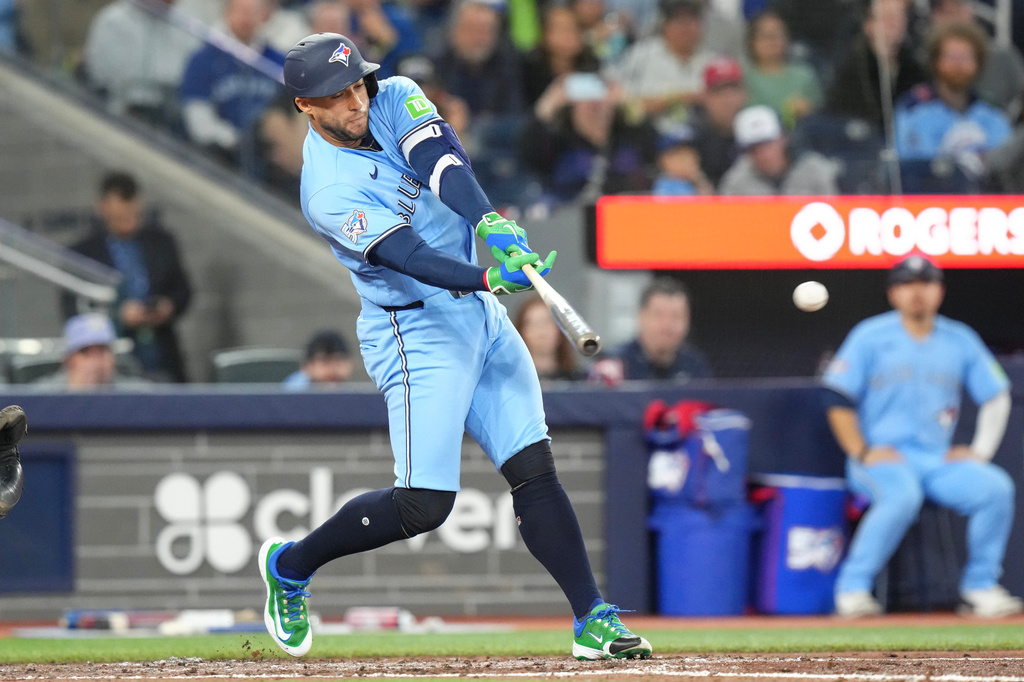 Toronto Blue Jays' George Springer (4) reacts as he sets off for first base after hitting an RBI single off Boston Red Sox pitcher Jovani Morán (47) during the fifth inning of a baseball game in Toronto, Wednesday, April 29, 2026. (Chris Young/The Canadian Press via AP)