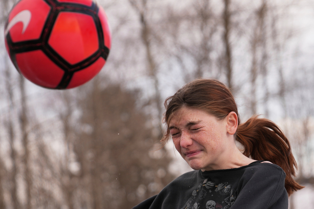 FILE - Parker Tirrell, a transgender athlete who plays on her high school's girls soccer team, heads the ball, Friday, March 7, 2025, in Plymouth, N.H. (AP Photo/Charles Krupa, File)