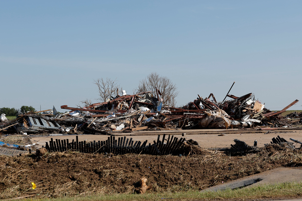 A commercial shop left in a pile of debris Friday, April 24, 2026, in a neighborhood that was damaged by a tornado Thursday in Enid, Okla. (AP Photo/Alonzo Adams)