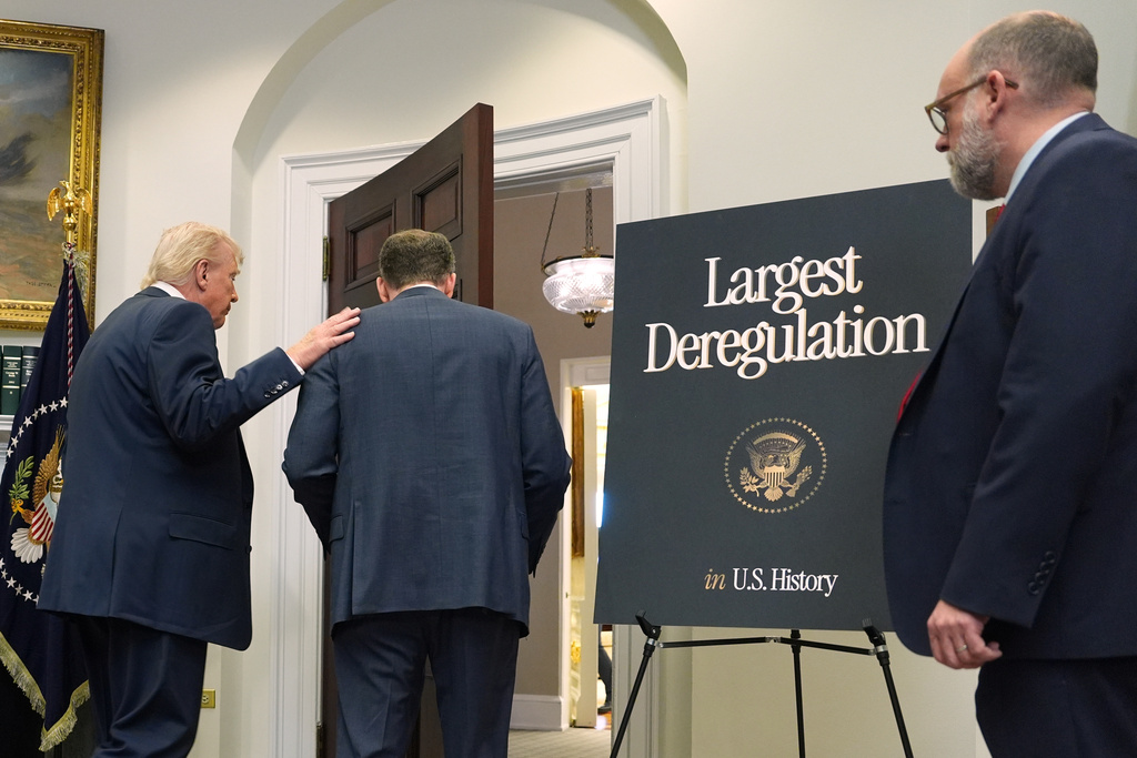 President Donald Trump departs with Environmental Protection Agency director Lee Zeldin and Office of Management and Budget director Russell Vought, right after announcing the EPA will no longer regulate greenhouse gases, in the Roosevelt Room of the White House, Thursday, Feb. 12, 2026, in Washington. (AP Photo/Evan Vucci)
