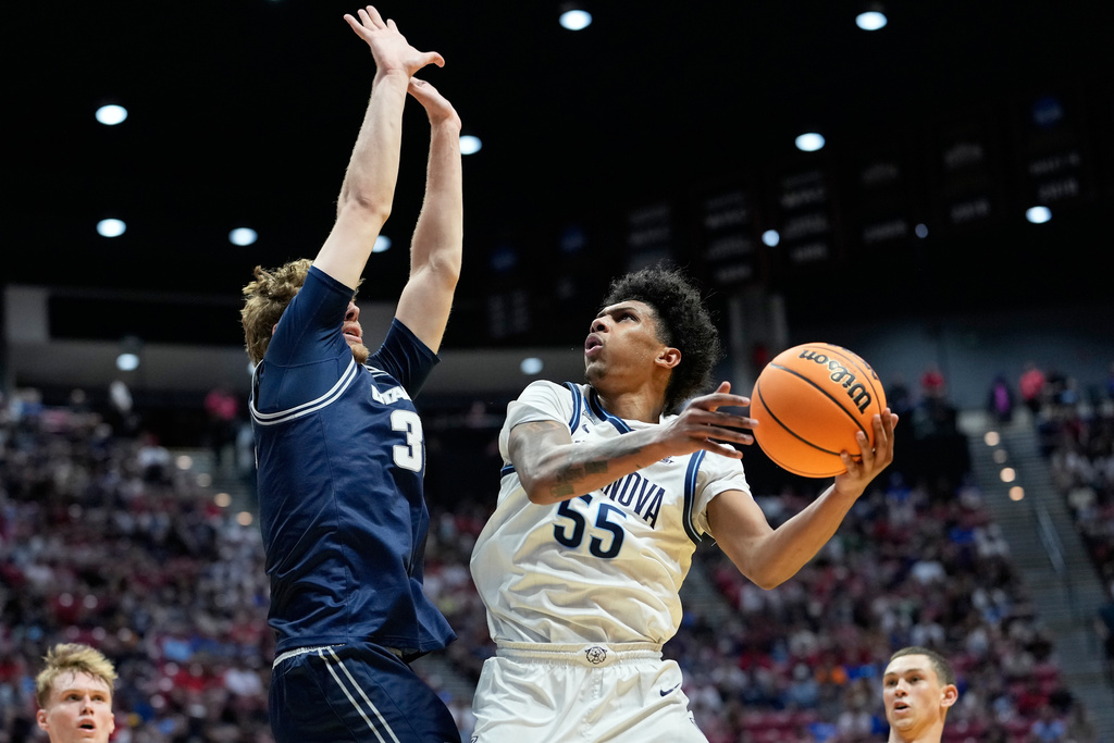 Villanova guard Acaden Lewis (55) shoots against Utah State forward Zach Keller during the second half in the first round of the NCAA college basketball tournament, Friday, March 20, 2026, in San Diego. (AP Photo/Mark J. Terrill)