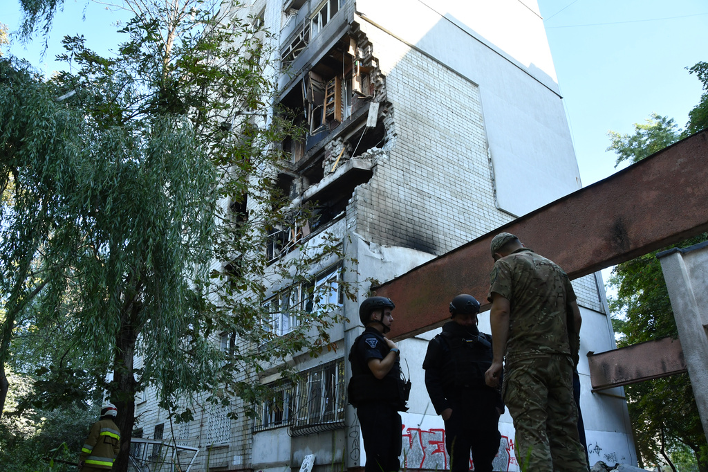 Rescuers work at the damaged apartment building following a Russian air attack in Lviv, Ukraine, Thursday, July 30, 2026. (AP Photo/Mykola Tys)