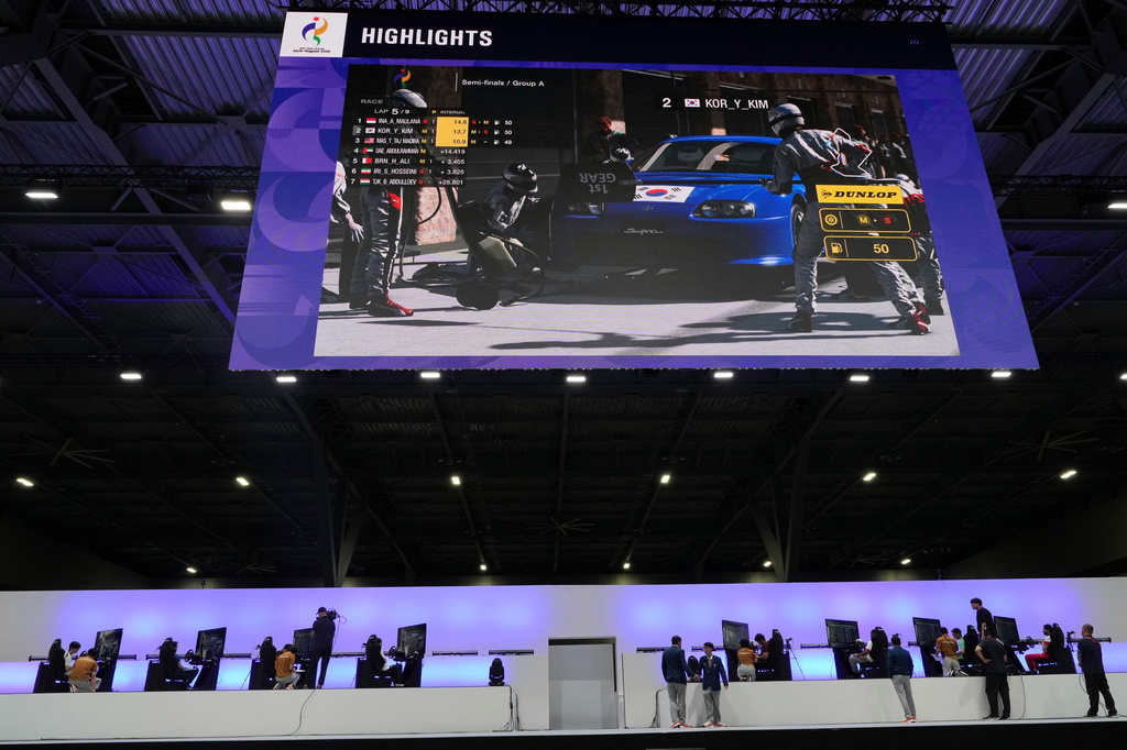 Competitors wait for final results following the Esports auto racing Gran Truismo 7 final at the Asian Games in Nagoya, Japan, Wednesday, Sept. 23, 2026. (AP Photo/Mark Baker)