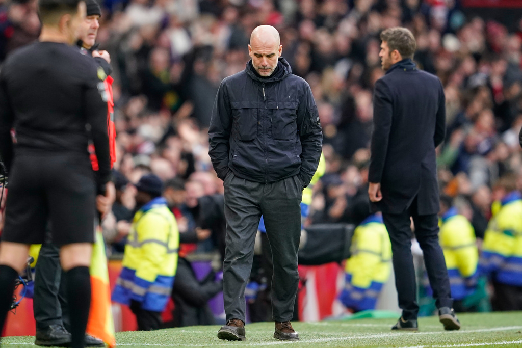 Manchester City's head coach Pep Guardiola walks during the English Premier League soccer match between Manchester United and Manchester City in Manchester, England, Saturday, Jan. 17, 2026. (AP Photo/Dave Thompson)