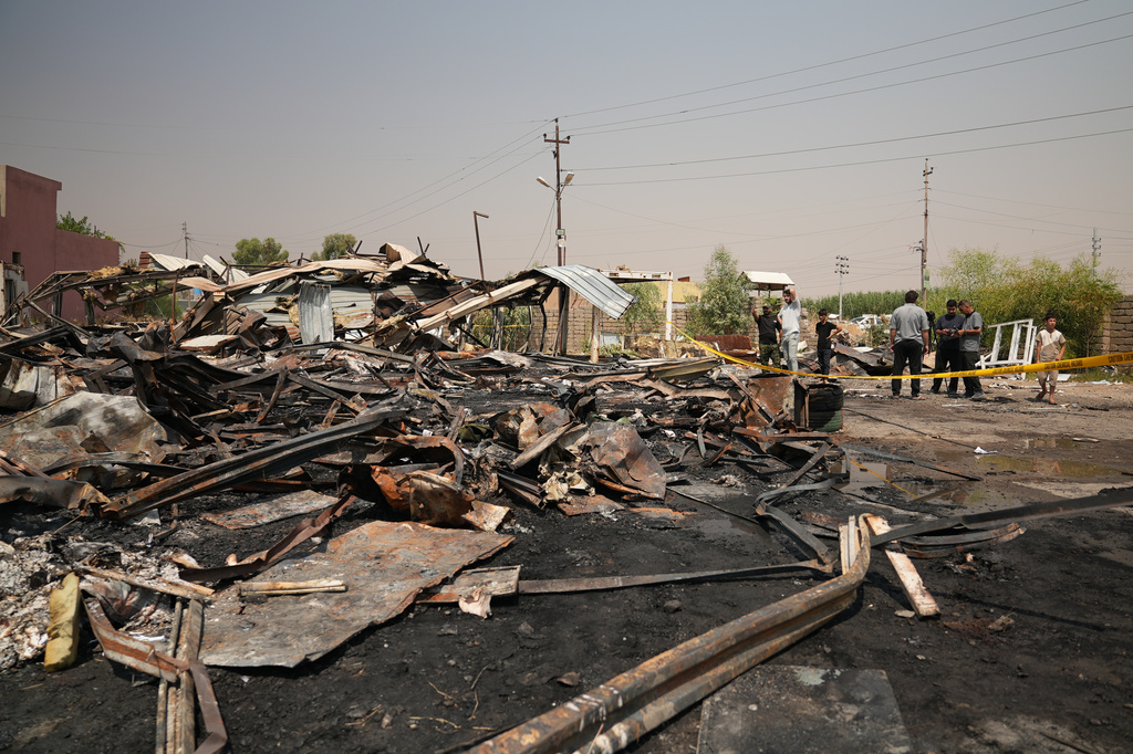 Iraqis inspect damaged structures at the site of an airstrike on a Popular Mobilization Forces base in Mosul, Iraq, Wednesday, July 29, 2026. (AP Photo/Farid Abdulwahed)