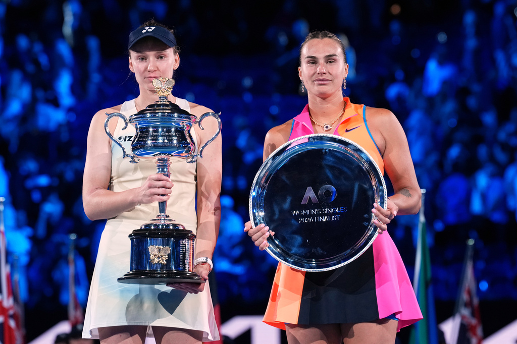 FILE - Elena Rybakina, left, of Kazakhstan, holds the Daphne Akhurst Memorial Cup after defeating Aryna Sabalenka, right, of Belarus, in the women's singles final at the Australian Open tennis championship in Melbourne, Australia, Jan. 31, 2026. (AP Photo/Dita Alangkara, File)
