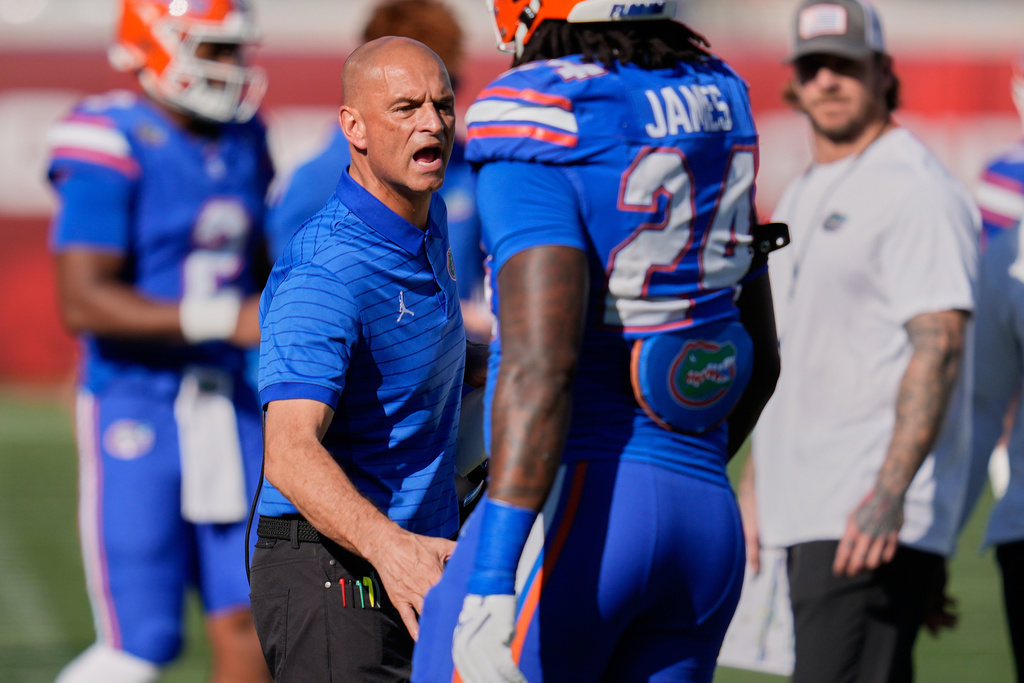 Florida interim head coach Billy Gonzales, left, encourages Florida defensive end Kamran James (24) during timeout in the first half of an NCAA college football game against Georgia Saturday, Nov. 1, 2025, in Jacksonville, Fla. (AP Photo/John Raoux)