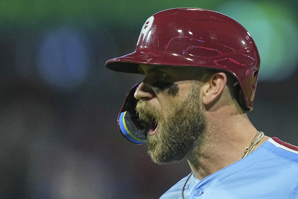 Philadelphia Phillies' Bryce Harper reacts after hitting an RBI single off of New York Mets pitcher Brooks Raley during the sixth inning of a baseball game, Thursday, Sept. 11, 2025, in Philadelphia. (AP Photo/Matt Rourke)
