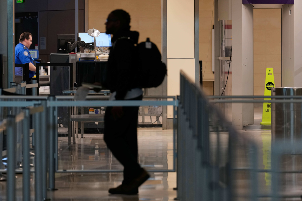 A lone traveler approaches a TSA checkpoint at Love Field Airport Saturday, Jan. 24, 2026, in Dallas. (AP Photo/Tony Gutierrez)