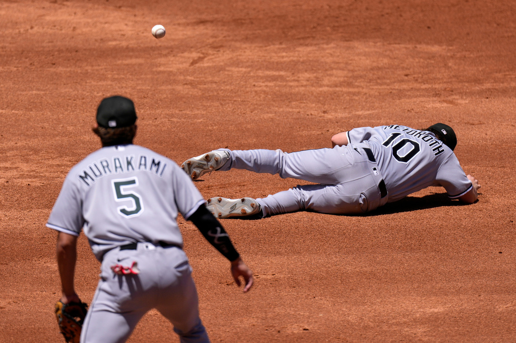 Chicago White Sox second baseman Chase Meidroth, right, falls while trying to catch a pop fly hit by Los Angeles Angels' Mike Trout as second baseman Vaughn Grissom watches during the second inning of a baseball game Wednesday, May 6, 2026, in Anaheim, Calif. (AP Photo/Mark J. Terrill)