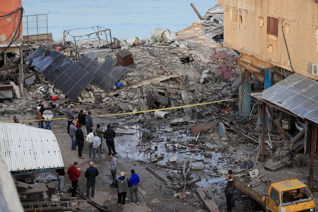 People check a destroyed building that was hit by an Israeli airstrike at a commercial district in the southern port city of Sidon, Lebanon, Tuesday, Jan. 6, 2026. (AP Photo/Mohammed Zaatari)