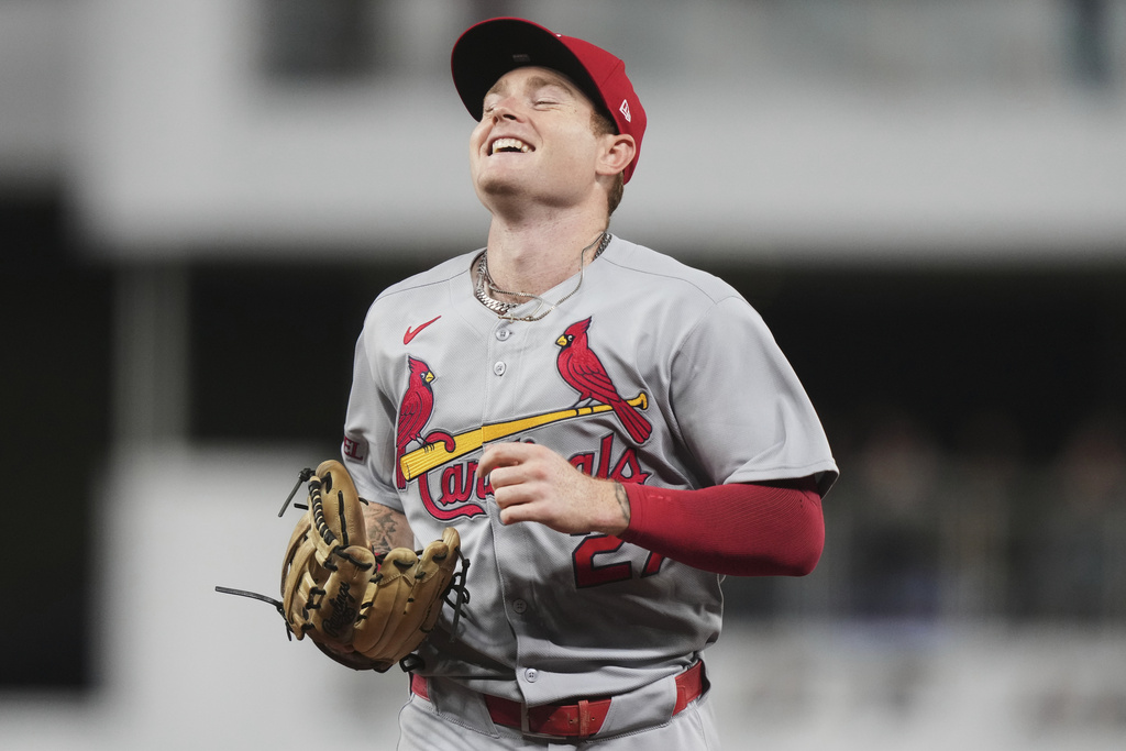 St. Louis Cardinals center fielder Nathan Church smiles as he runs off the field after catching a fly ball at the wall hit by Miami Marlins' Heriberto Hernandez during the fourth inning of a baseball game, Tuesday, Aug. 19, 2025, in Miami. (AP Photo/Lynne Sladky)