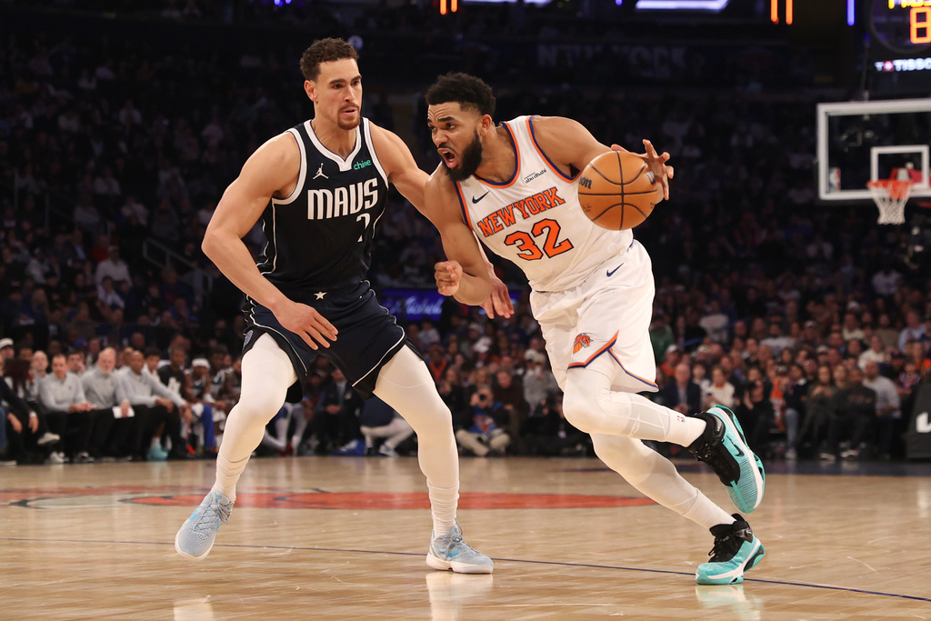 New York Knicks' Karl-Anthony Towns (32) dribbles against Dallas Mavericks' Dwight Powell, left, during the first half of an NBA basketball game, Monday, Jan. 19, 2026, in New York. (AP Photo/Pamela Smith)