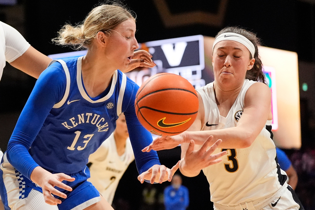 Vanderbilt guard Aubrey Galvan (3) tries to steal the ball from Kentucky center Clara Strack (13) during the first half of an NCAA college basketball game Sunday, Feb. 22, 2026, in Nashville, Tenn. (AP Photo/George Walker IV)