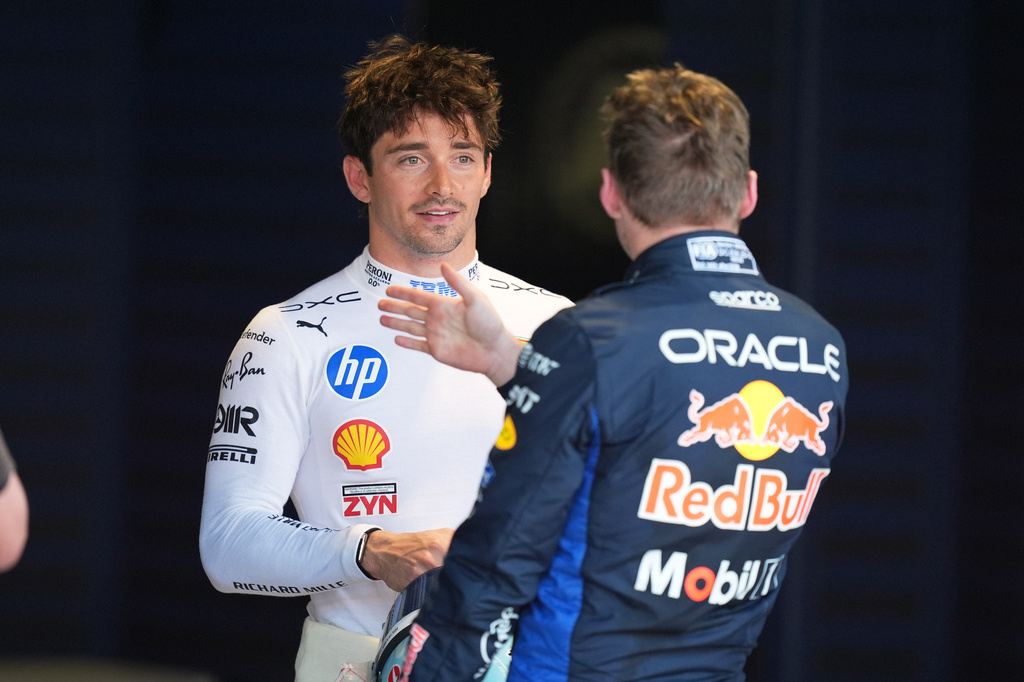 Ferrari driver Arthur Leclerc of Monaco, left, talks with Red Bull driver Max Verstappen of the Netherlands after a qualifying session for the Miami Formula One Grand Prix auto race, Saturday, May 2, 2026, in Miami Gardens, Fla. (AP Photo/Rebecca Blackwell)