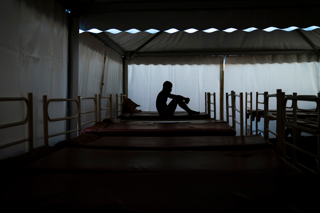 FILE - Mamadou Patherazi, from Guinea, sits on a bench at the Modern Christian Mission church in Fuerteventura, Canary Islands, Spain, on Aug. 22, 2020. (AP Photo/Emilio Morenatti, File)