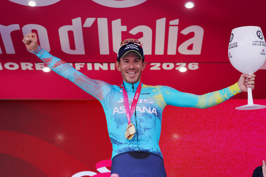 Italy's Davide Ballerini celebrates on the podium after winning the 6th stage of the Giro d'Italia cycling race, from Paestum to Naples, Italy, Thursday, May 14, 2026. (Massimo Paolone/LaPresse via AP)