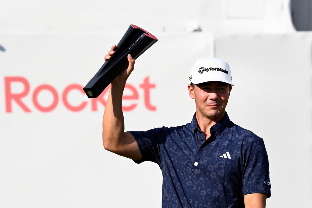Michael Thorbjornsen hoists the trophy after winning the Rocket Classic golf tournament, Sunday, Aug. 2, 2026, in Detroit. (AP Photo/Jose Juarez)