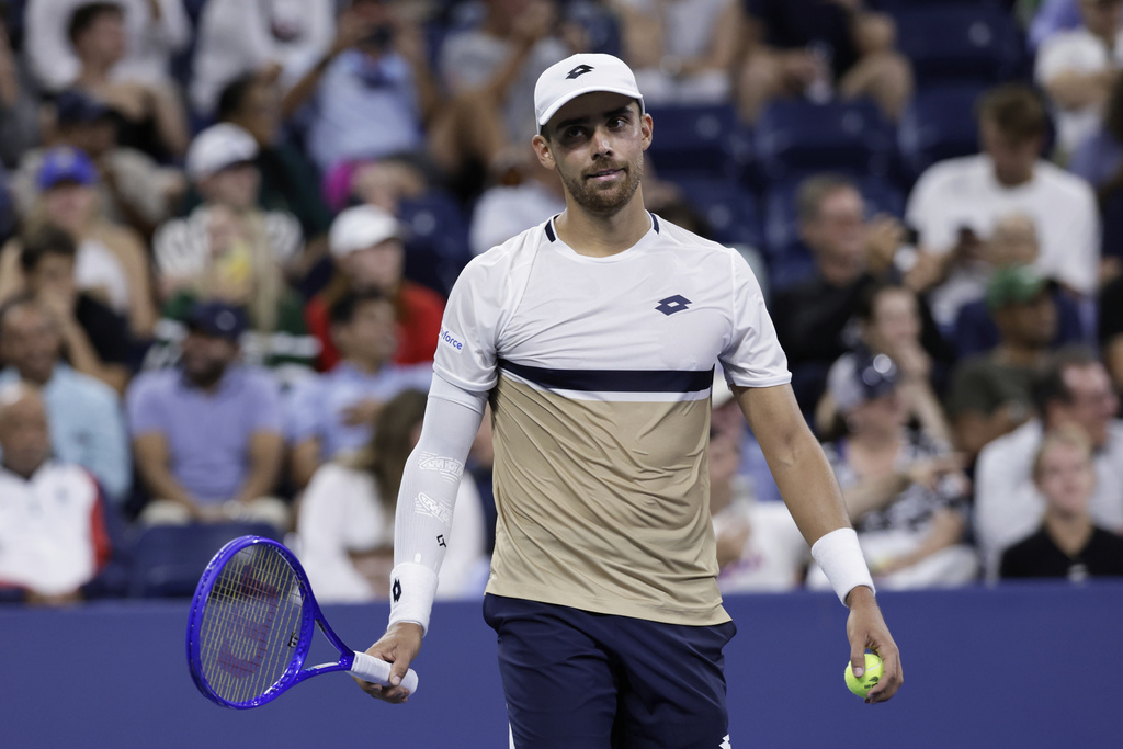 Benjamin Bonzi, of France, reacts during a match against Daniil Medvedev, of Russia, in the first-round of the U.S. Open tennis championships, Sunday, Aug. 24, 2025, in New York. (AP Photo/Adam Hunger)