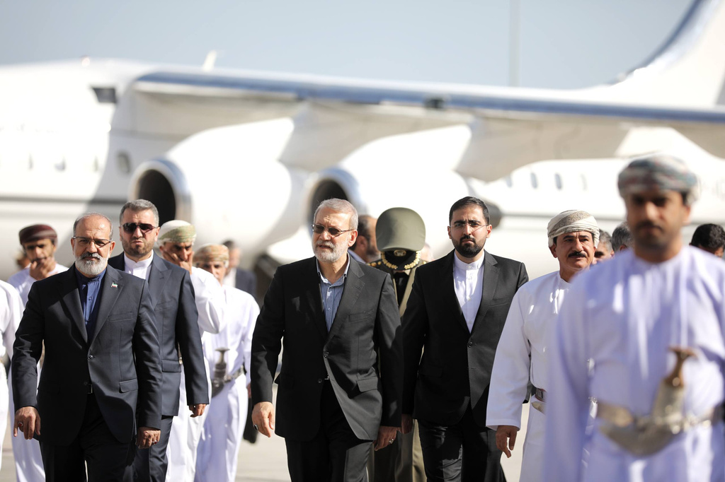 In this photo released by Iran's Supreme National Security Council office, Secretary of the Supreme National Security Council Ali Larijani, center, arrives in Muscat, Oman, Tuesday, Feb. 10, 2026. (Erfan Kouchari/Iran's Supreme National Security Council Office via AP)