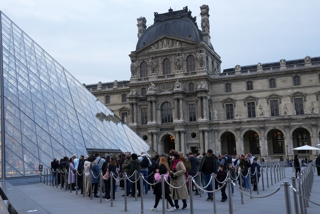 Visitors queue to enter the Louvre museum three days after historic jewels were stolen in a daring daylight heist, Wednesday, Oct. 22, 2025 in Paris. (AP Photo/Thibault Camus)
