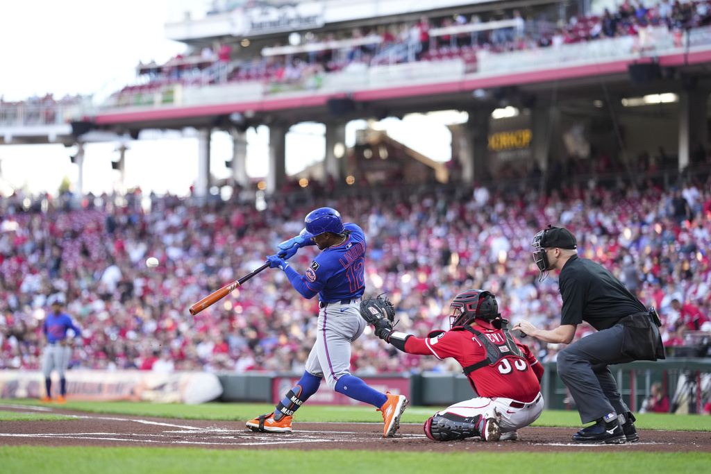 New York Mets' Francisco Lindor (12) hits a single during the first inning of a baseball game against the Cincinnati Reds, Saturday, Sept. 6, 2025, in Cincinnati. (AP Photo/Jeff Dean)