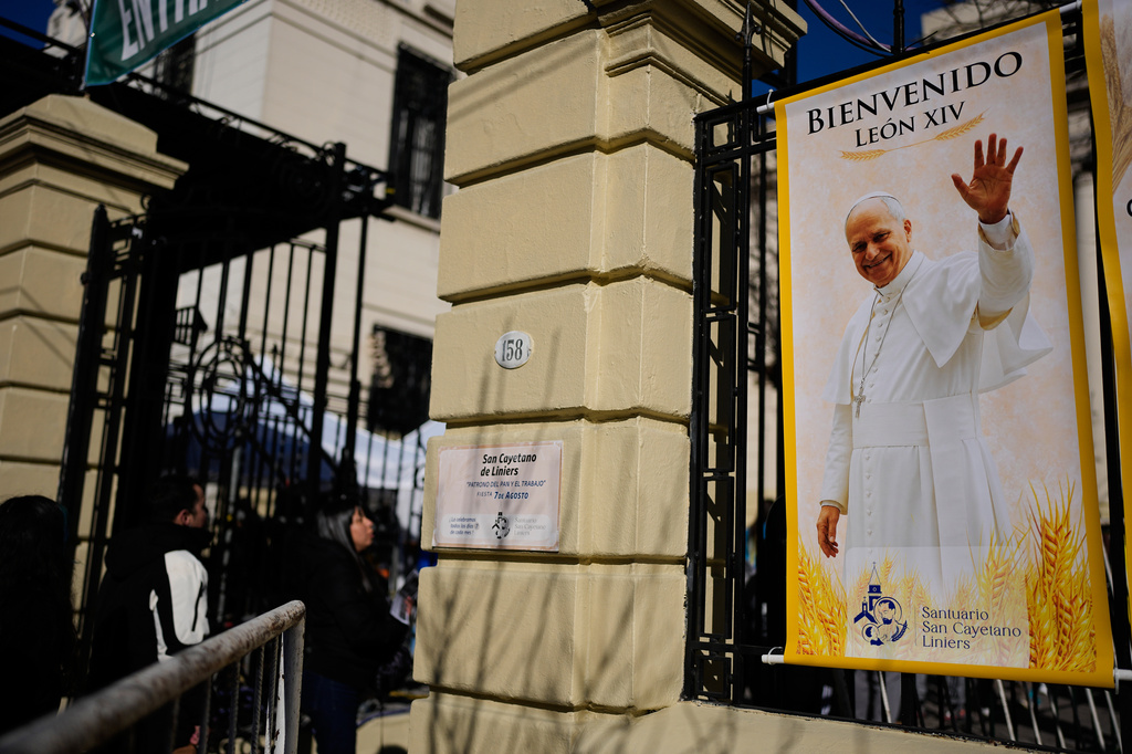 A banner of Pope Leo XIV is posted outside the Church of San Cayetano during the annual pilgrimage honoring Saint Cajetan, the patron saint of work, in Buenos Aires, Argentina, Friday, Aug. 7, 2026. (AP Photo/Natacha Pisarenko)