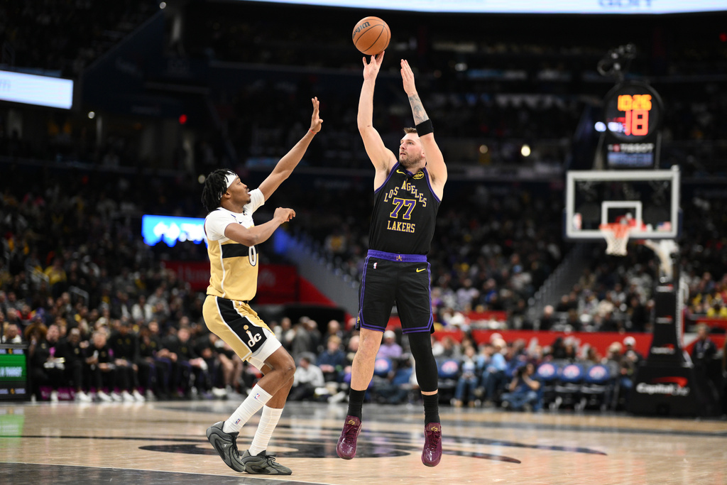 Los Angeles Lakers guard Luka Doncic (77) shoots against Washington Wizards guard Bilal Coulibaly (0) during the second half of an NBA basketball game, Friday, Jan. 30, 2026, in Washington. (AP Photo/Nick Wass)