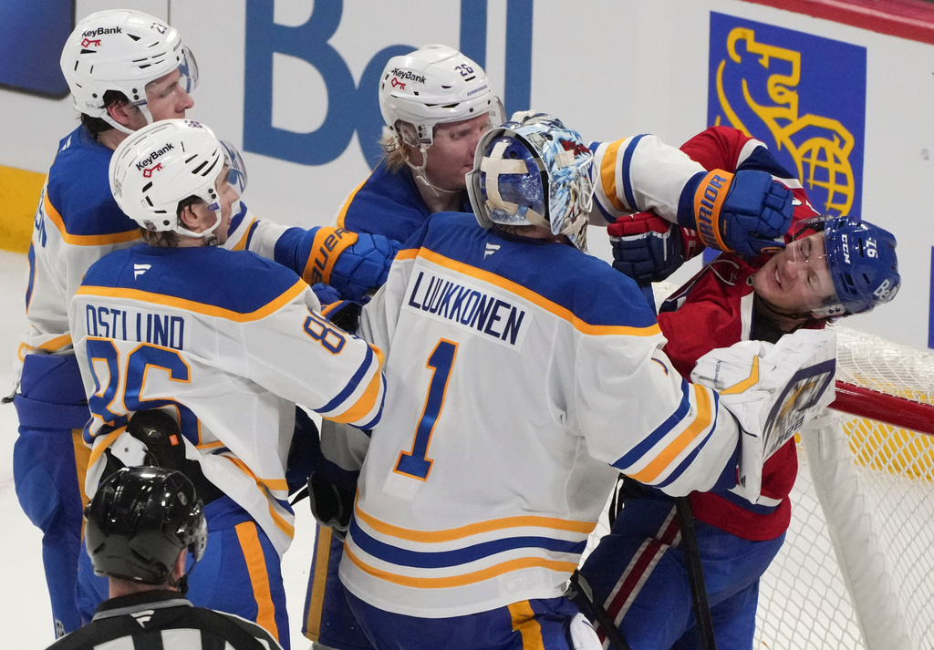 Montreal Canadiens' Zachary Bolduc (76) is cuffed by Buffalo Sabres' Rasmus Dahlin (26) as Sabres goaltender Ukko-Pekka Luukkonen (1), Noah Ostlund (86) and Mattias Samuelsson (23) look on during second-period NHL hockey game action in Montreal, Thursday, Jan. 22, 2026. (Christinne Muschi/The Canadian Press via AP)