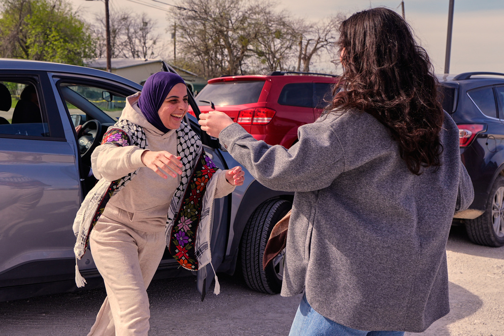 Leqaa Kordia, left, moves to embrace friends, family and suppporters after being released from the Prairieland Detention Center in Alvarado, Texas, Monday, March 16, 2026. (AP Photo/Tony Gutierrez)