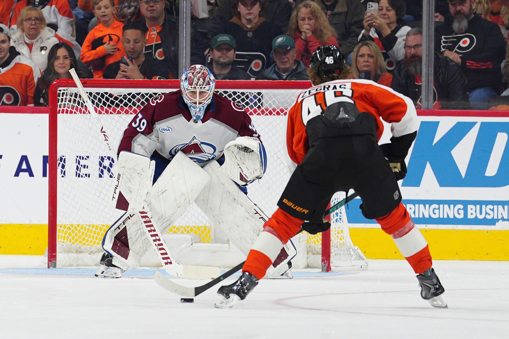 Colorado Avalanche goaltender Mackenzie Blackwood watches as Philadelphia Flyers' Trevor Zegras (46) skates in on a penalty shot during the third period of an NHL hockey game, Sunday, Dec. 7, 2025, in Philadelphia. (AP Photo/Derik Hamilton)