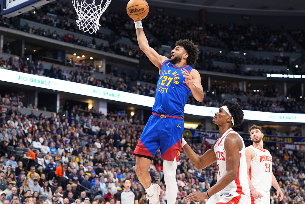 Denver Nuggets guard Jamal Murray, left, drives to the rim past Houston Rockets forward Amen Thompson in the first half of an NBA basketball game, Wednesday, March 11, 2026, in Denver. (AP Photo/David Zalubowski)