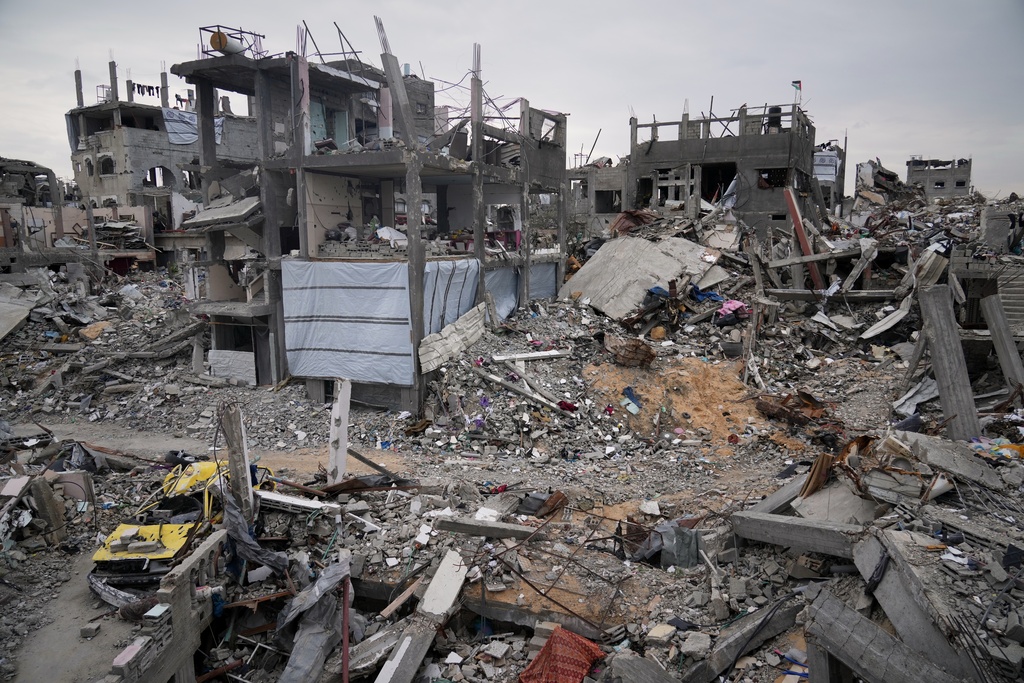 Ruins of apartments destroyed by Israeli strikes litter the area next to Khaled Nassar's home in the Jabaliya refugee camp in Gaza City Feb. 9, 2025. Nassar's daughter, Dalia, and his son, Mahmoud, were killed in separate airstrikes, leaving both buried under their homes. (AP Photo/Abdel Hana)